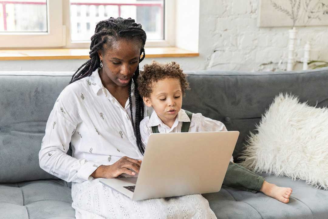 Mother and child using laptop together